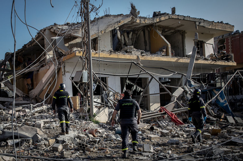 Firefighters search a building for survivors shortly after an Israeli airstrike on April 13, 2026 in Nabatieh, Lebanon.