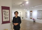 Artist Kim Chang-soon, also known as Laura Kim, stands among her works during her solo exhibition in Los Angeles, which highlighted more than seven decades of calligraphy shaped by faith, perseverance and artistic discipline.
