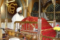 Sikh ceremonial reader reciting from the Guru Granth Sahib.