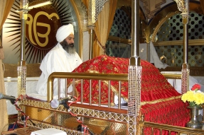 Sikh ceremonial reader reciting from the Guru Granth Sahib.