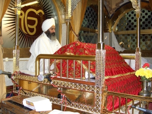 Sikh ceremonial reader reciting from the Guru Granth Sahib.