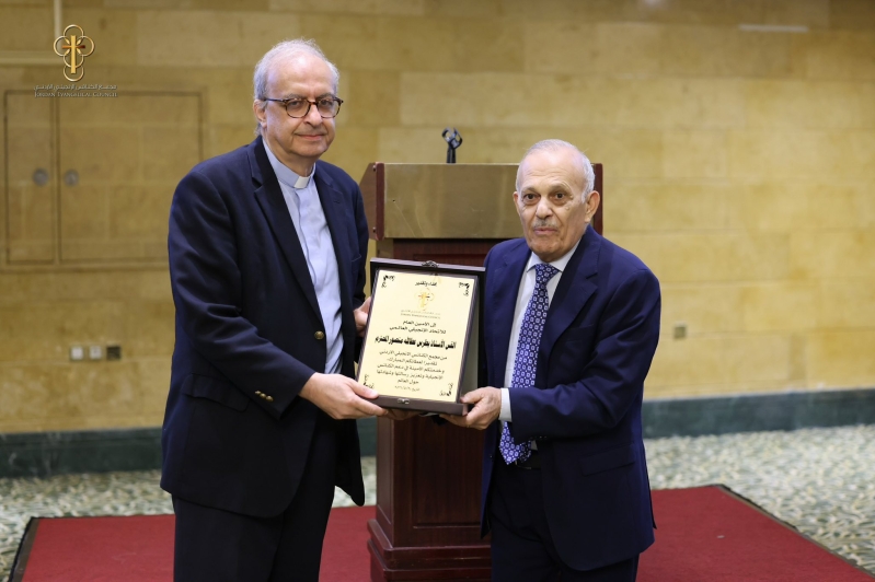 The president of the Jordan Evangelical Council presents a commemorative plaque to World Evangelical Alliance Secretary General Rev. Botrus Mansour at a ceremony hosted by the council on May 30, the day after Jordans centennial celebration of organized e