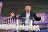 Asia Evangelical Alliance General Secretary Dr. Bambang Budijanto prays over white flags bearing the names of churches delegates committed to help transition toward disciple-making, during the closing ceremony of the Asia Conference on Church & Mission 20
