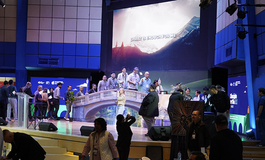 Delegates cross a symbolic bridge carrying white flags during the closing ceremony of the Asia Conference on Church & Mission 2026 in Alabang, Metro Manila, June 11, 2026. Each flag bore the name of a church or community the delegate committed before God 