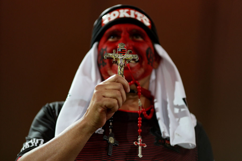 A fan of Flamengo prays before a match