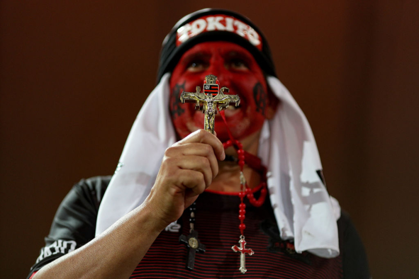 A fan of Flamengo prays before a match