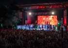 Thousands attend the Visit Jordan Experience, where performers in traditional dress appear onstage before a screen showing Petra.