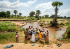 Rev. Joseph Tia Sugri reads Scripture to members of Nanyeeri Baptist Church during a baptismal service at a river in northeastern Ghana. African theologians say creation is already woven into African Christian spirituality — not reserved for a special day