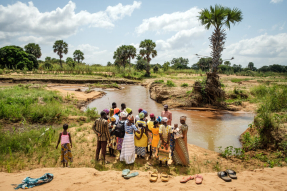 Rev. Joseph Tia Sugri reads Scripture to members of Nanyeeri Baptist Church during a baptismal service at a river in northeastern Ghana. African theologians say creation is already woven into African Christian spirituality — not reserved for a special day