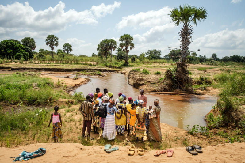 Rev. Joseph Tia Sugri reads Scripture to members of Nanyeeri Baptist Church during a baptismal service at a river in northeastern Ghana. African theologians say creation is already woven into African Christian spirituality — not reserved for a special day