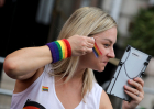 LONDON, ENGLAND - JULY 4: A parade-goer applies rainbow face paint ahead of the Pride In London 2026 parade on July 4, 2026 in London, England.