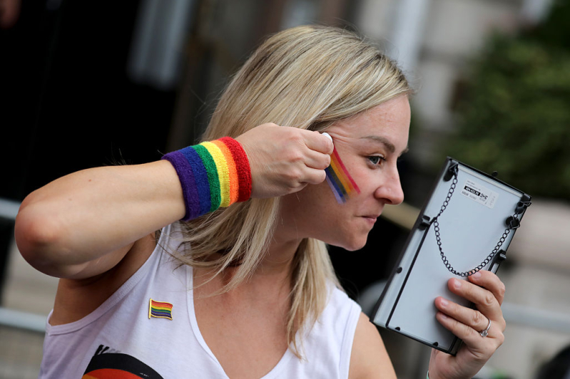 LONDON, ENGLAND - JULY 4: A parade-goer applies rainbow face paint ahead of the Pride In London 2026 parade on July 4, 2026 in London, England.