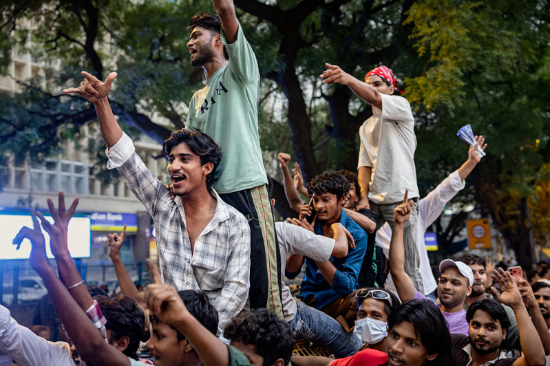 Supporters of Indias Cockroach Janta Party (CJP) ride a barricade during a protest demand the resignation of Education Minister Dharmendra Pradhan over examination paper leaks, at Jantar Mantar on July 24, 2026 in New Delhi, India