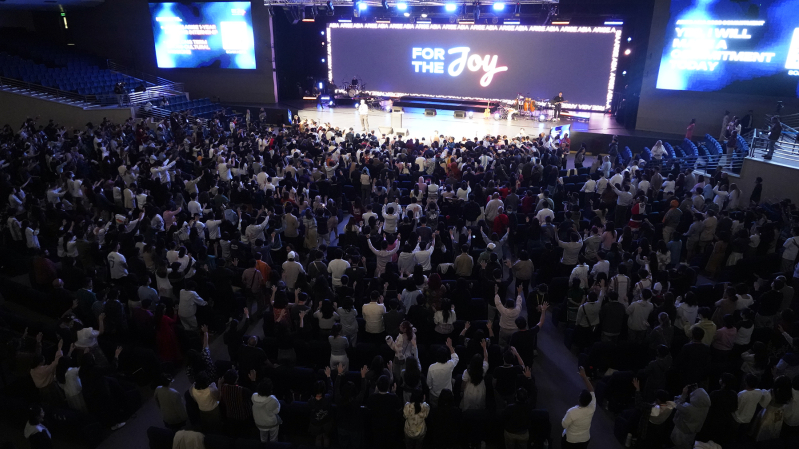 Pastors, missionaries and senior leaders pray over young leaders who came to the front after committing to long-term cross-cultural mission during the evening session of the Arise Asia 2026 Congress at Christs Commission Fellowship Central in Manila, Phi