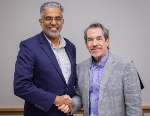 Stephen George, president of Evangelical Theological Seminary in India, and Michael Ortiz, vice president for global ministries at Dallas Theological Seminary, shake hands following the signing of a partnership agreement to launch a new Christian counseli