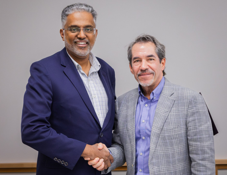 Stephen George, president of Evangelical Theological Seminary in India, and Michael Ortiz, vice president for global ministries at Dallas Theological Seminary, shake hands following the signing of a partnership agreement to launch a new Christian counseli