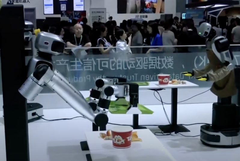 Humanoid robots demonstrate household food-handling tasks at the World Robot Conference in Beijing, Aug. 19, 2026.