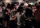 Worshippers stand together during a church service.