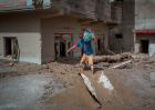 DEVIGHAT, NEPAL - AUGUST 28: A resident carries belongings he salvaged from his destroyed home following flash floods on August 28, 2026 in Devighat, Nepal.