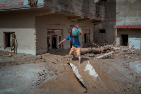 DEVIGHAT, NEPAL - AUGUST 28: A resident carries belongings he salvaged from his destroyed home following flash floods on August 28, 2026 in Devighat, Nepal.