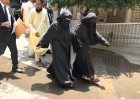 Neha Faqir (R) in Islamic dress on way to court in Lahore, Pakistan.