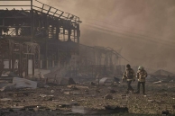 Firefighters walk through the remains of a warehouse and office complex used by the humanitarian ministry of Ukraine for Christ, destroyed in a Russian strike on the evening of Aug. 28, 2026.