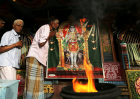 Minority ethnic Tamil men pray in the Hindu temple on August 12,2015 in Jaffna, Sri Lanka.