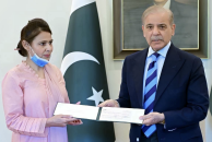 Prime Minister Shehbaz Sharif hands a check of 10 million Pakistani rupees ($36,000) to Christian Staff Nurse Razia Noreen during a meeting at PMs House on Thursday, Sept. 3, 2026.