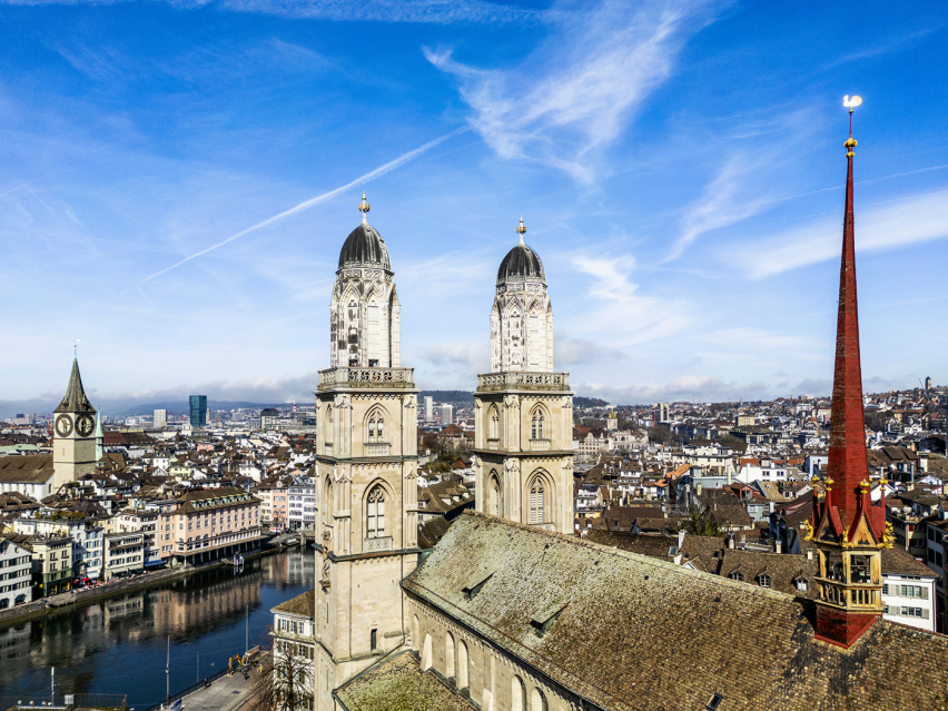The twin towers of the Grossmünster, where Huldrych Zwingli began preaching in 1519 and set the Swiss Reformation in motion, rise above the Limmat River in Zurichs old town.
