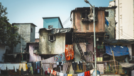 Facades of huts in a slum in South Asia. Poverty.