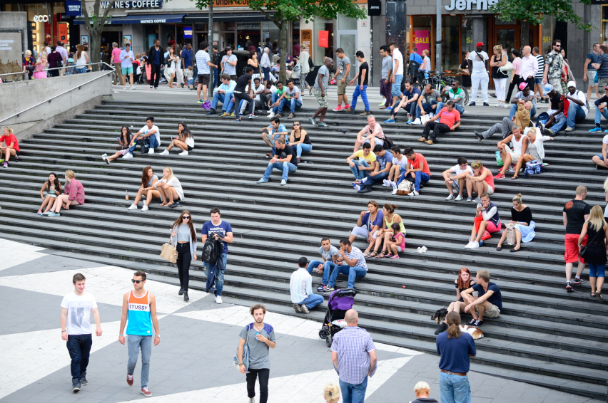 People sit on the steps at Sergels torg in Stockholm, Sweden.