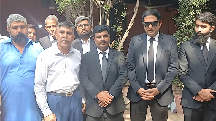 Shahbaz Masih (L), rights activist Safdar Choudhry (in blue pants) and legal team for Maria Shahbaz’s family outside the Lahore High Court on Oct. 1, 2026.