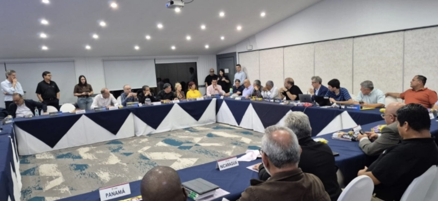 Participants sit at tables marked with country placards during the Latin Evangelical Alliance’s 13th General Assembly in San José, Costa Rica.
